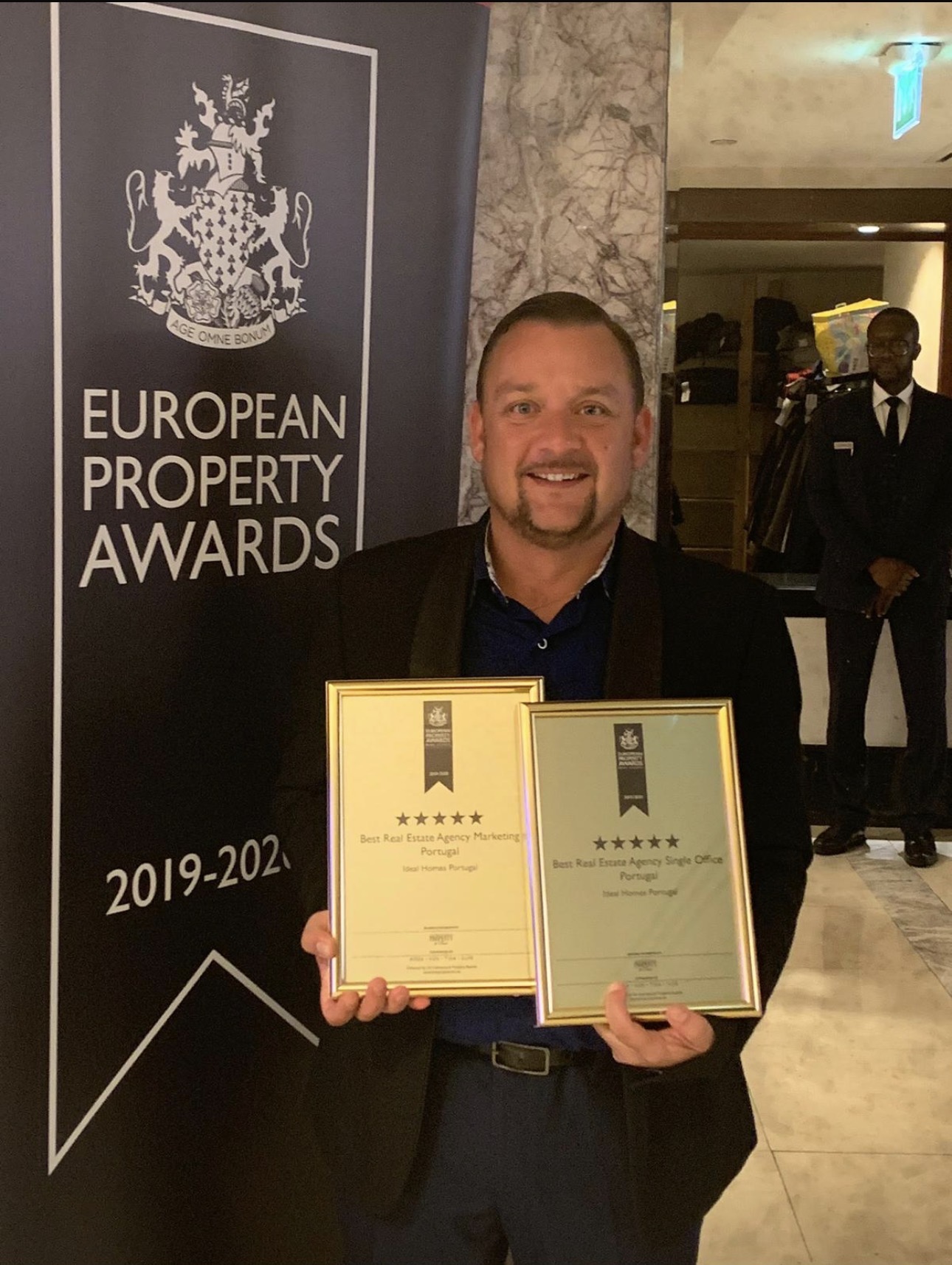 Chris White holding European Property Awards plaques